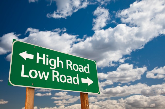 High Road, Low Road Green Road Sign with Copy Room Over The Dramatic Clouds and Sky.